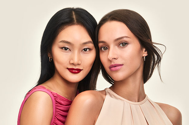 two models in front of a beige background