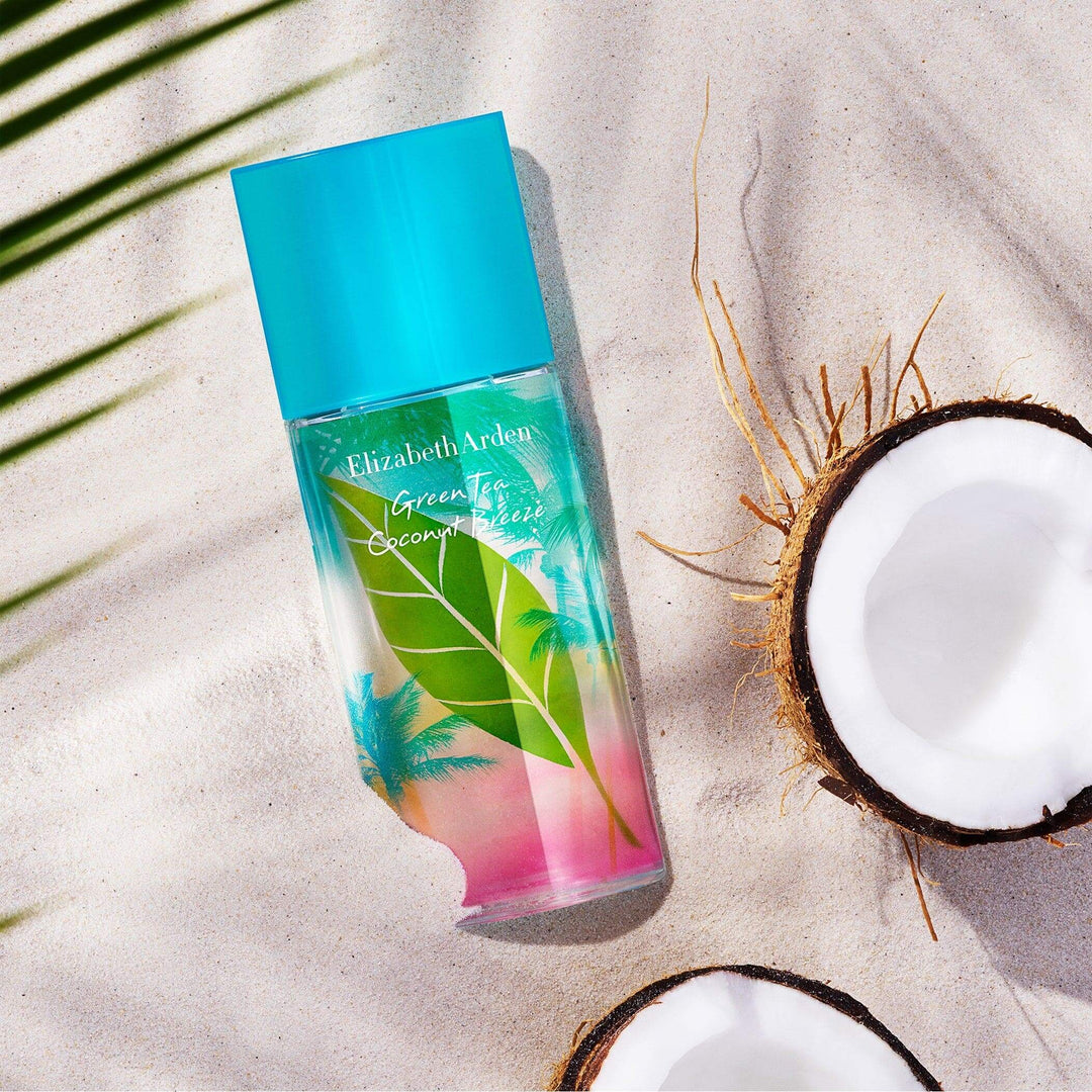 Green Tea Coconut Breeze Spray laying on sand